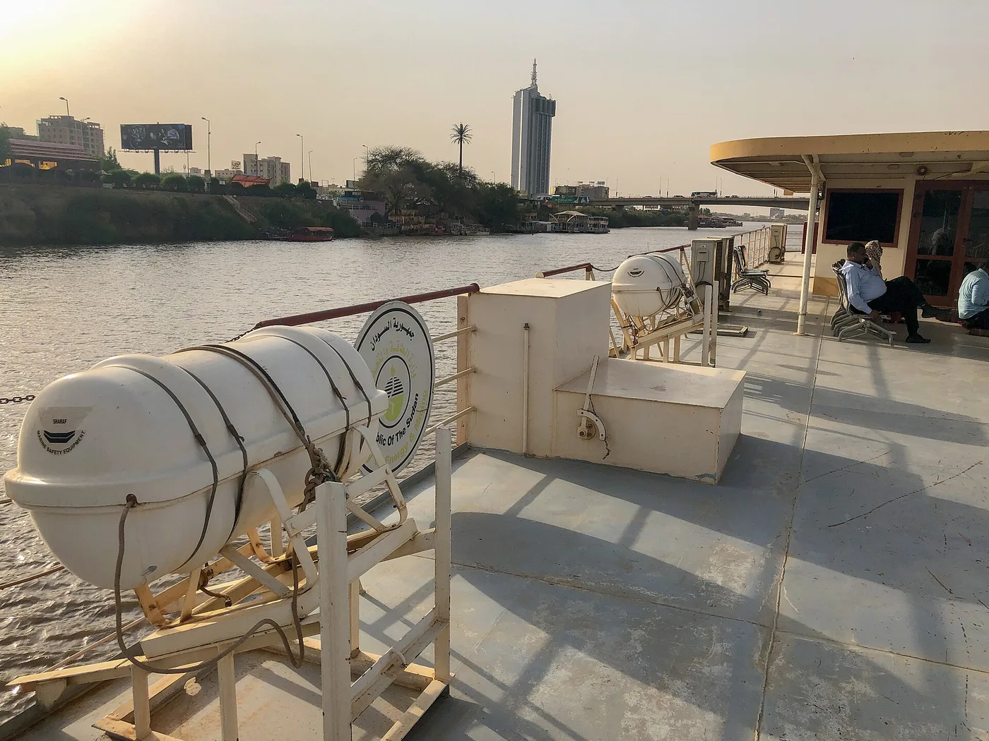 A ferry on the Blue Nile in Khartoum, with the city skyline beyond. Archive photo — it does not depict the fighting described in this article.