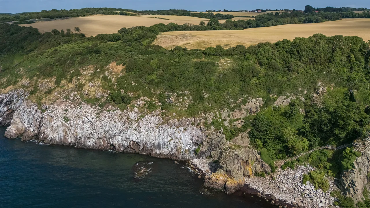 The rocky coast of Bornholm, Denmark (file photo). Prosecutors say the explosive charges were placed on the seabed near the island. This photo does not depict any event reported in this article.