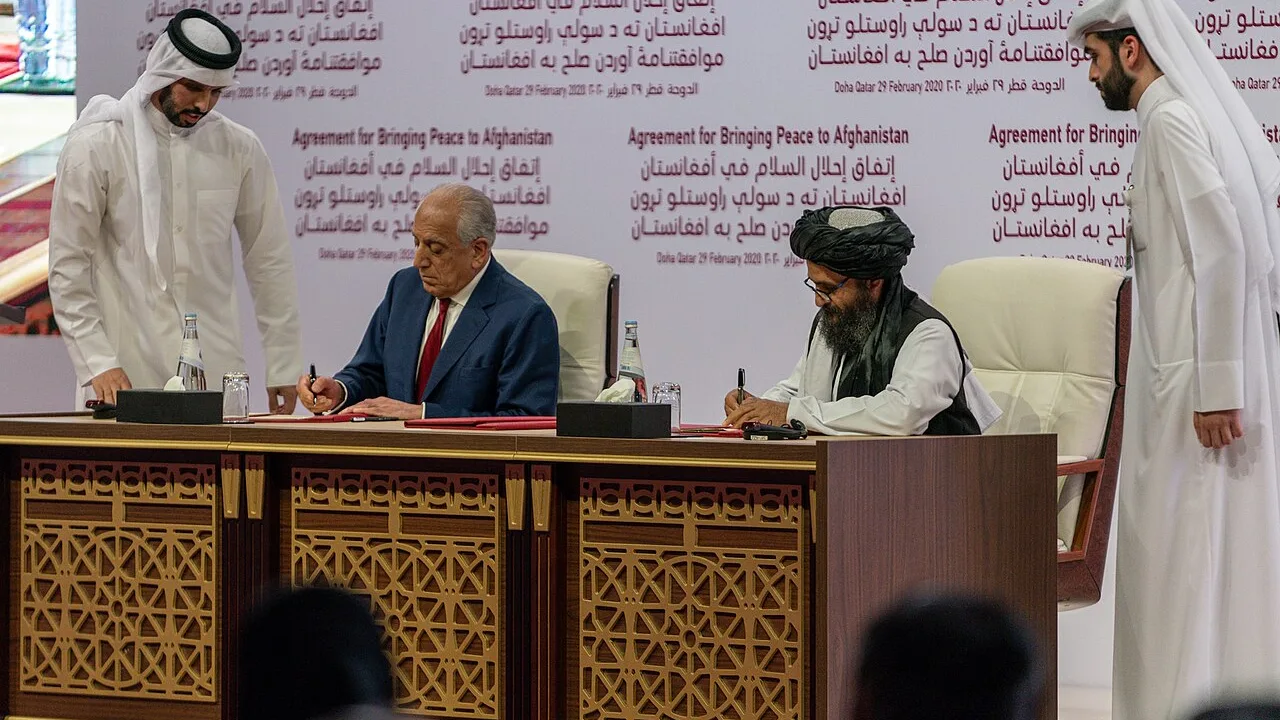 US special envoy Zalmay Khalilzad (left, seated) and Taliban co-founder Abdul Ghani Baradar signing the Agreement for Bringing Peace to Afghanistan in Doha, Qatar, on 29 February 2020 (US Department of State photo). The agreement set the withdrawal timetable that ended the war; the Afghan government was not a party to it.