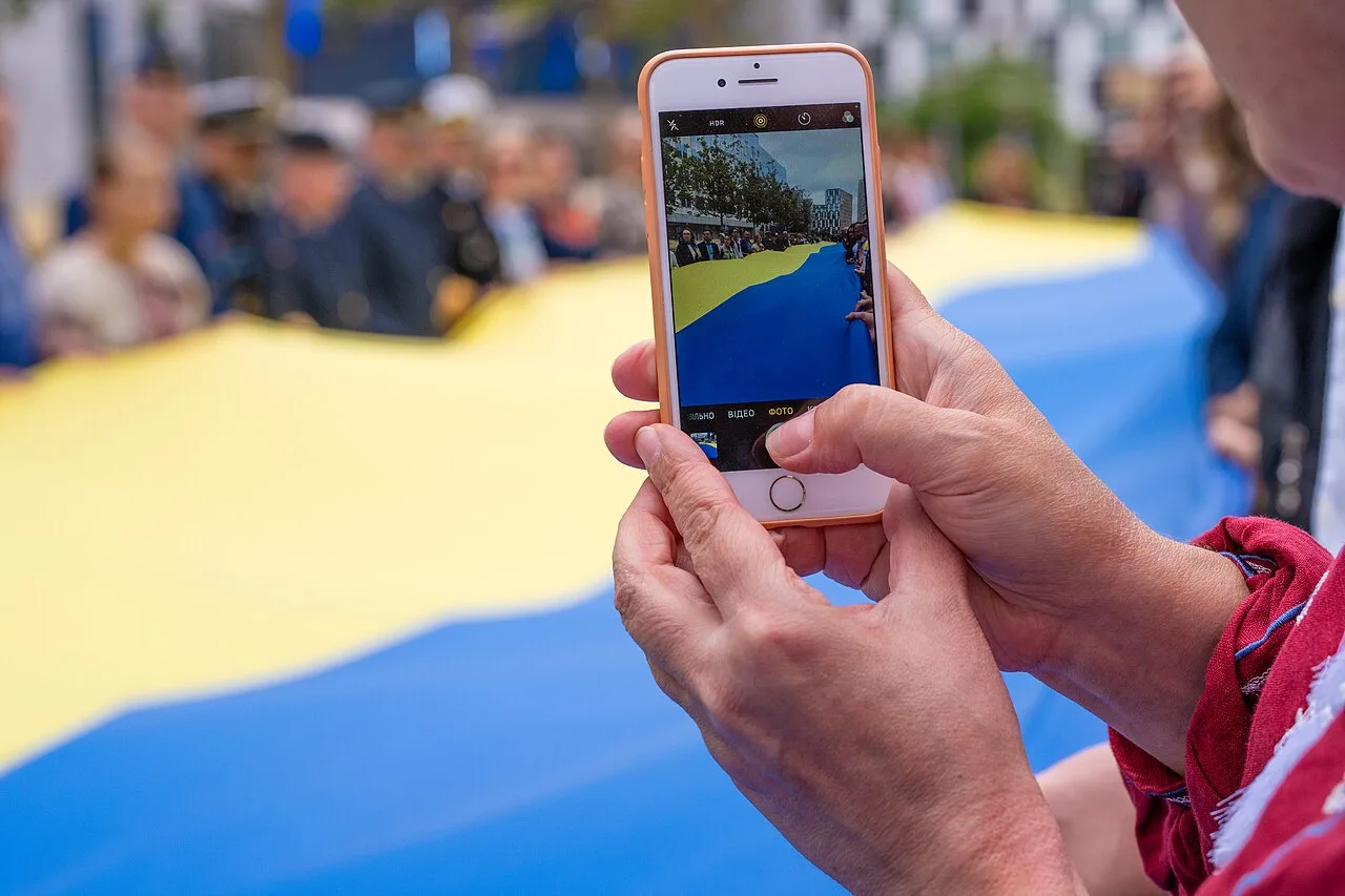An onlooker photographs a giant Ukrainian flag unfurled outside the European Parliament building in Brussels (file photo). This photo does not depict any event reported in this article.