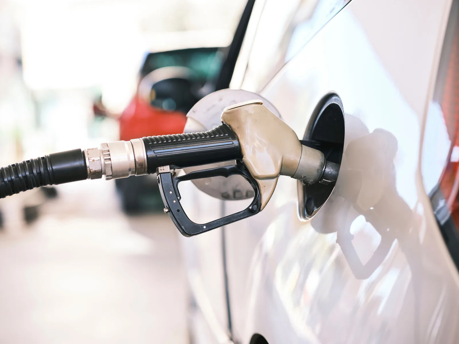 A fuel pump nozzle refuelling a car (file photo). Trump says Russian diesel will bring fuel prices down; analysts are sceptical Russia can deliver the promised volumes.
