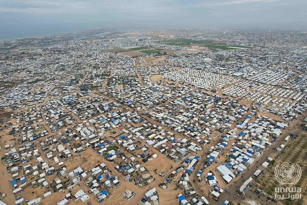 An aerial view of the al-Mawasi area of southern Gaza, where displaced Palestinians live in tents (file photo). A tent in Mawasi was among the sites hit in the strikes documented in this article; this photo does not depict any specific strike.