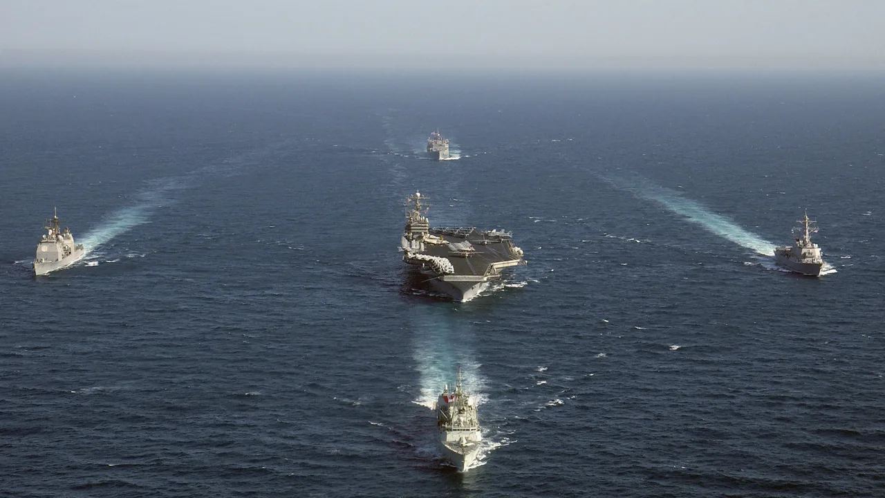 Ships assigned to the USS George Washington carrier strike group sail in formation in the Arabian Sea during an earlier deployment (file photo). This photo does not depict any current deployment, unit or event reported in this article.
