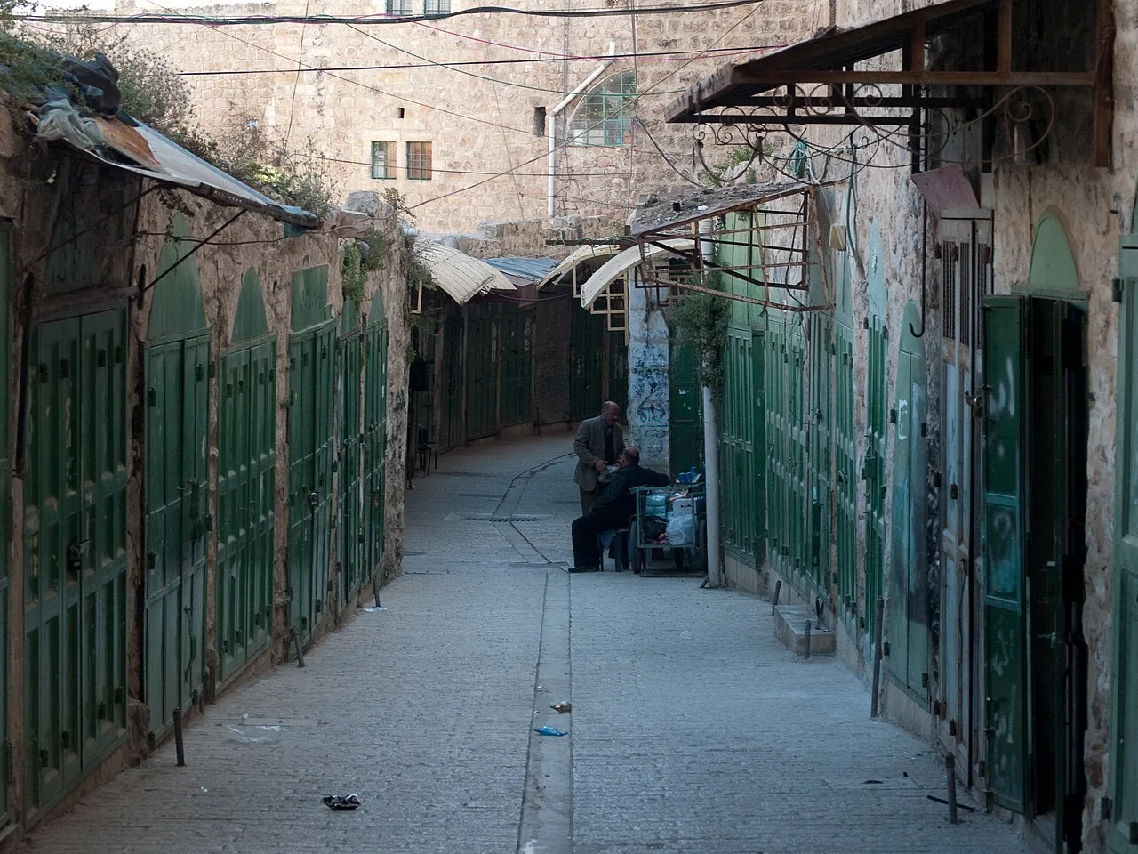 Shuttered shopfronts along an alley in Hebron's Old City, occupied West Bank (file photo, 2010). Israel has blocked the entrances to most West Bank cities and towns since Friday. This photo does not depict any event reported in this article.