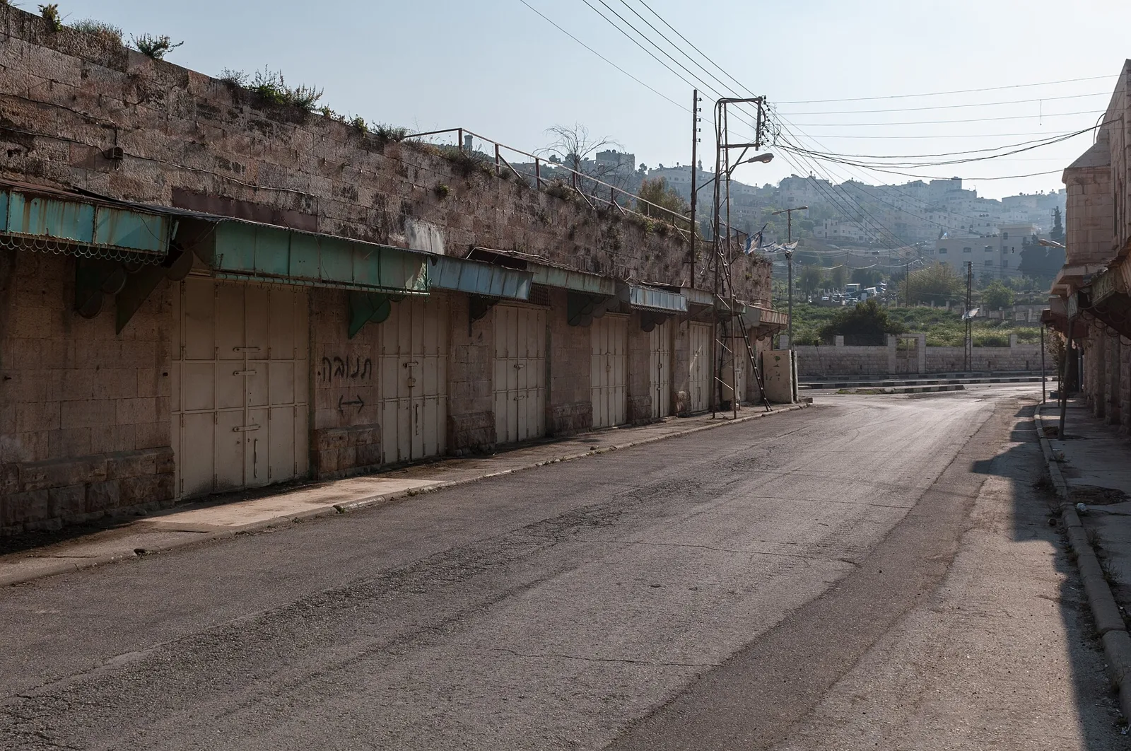 Shuttered shops on an empty street in Hebron's Old City, occupied West Bank (file photo). Israeli forces sealed the city and began demolitions in one neighbourhood on Friday after the checkpoint shooting. This photo does not depict any event reported in this article.