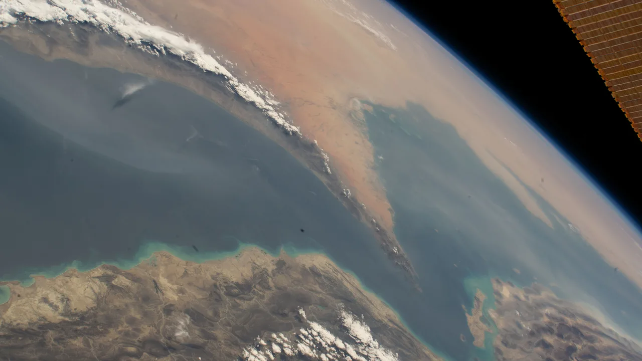 The Strait of Hormuz connecting the Gulf of Oman with the Persian Gulf, photographed from orbit (NASA file photo). This photo does not depict any event reported in this article.