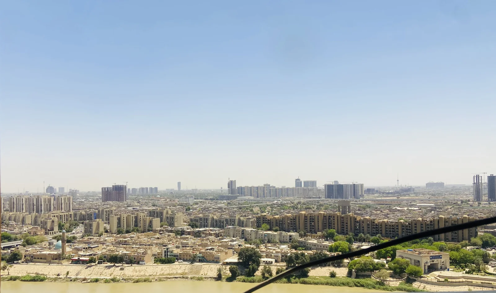 Daytime view across Baghdad, with the Tigris in the foreground. Generic photo; it does not depict the events described in this article.