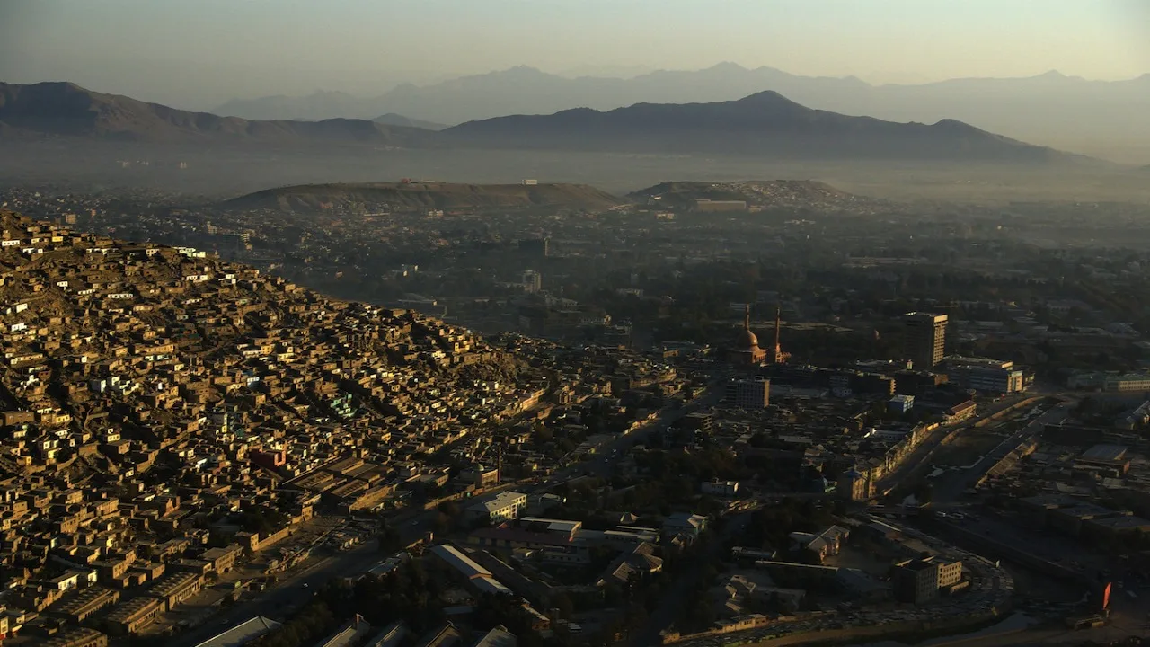 Kabul seen from the air, its hillside housing climbing the slopes above the city centre (file photo). Kabul fell to the Northern Alliance in November 2001 and to the Taliban, twenty years later, on 15 August 2021. This photo does not depict the war.