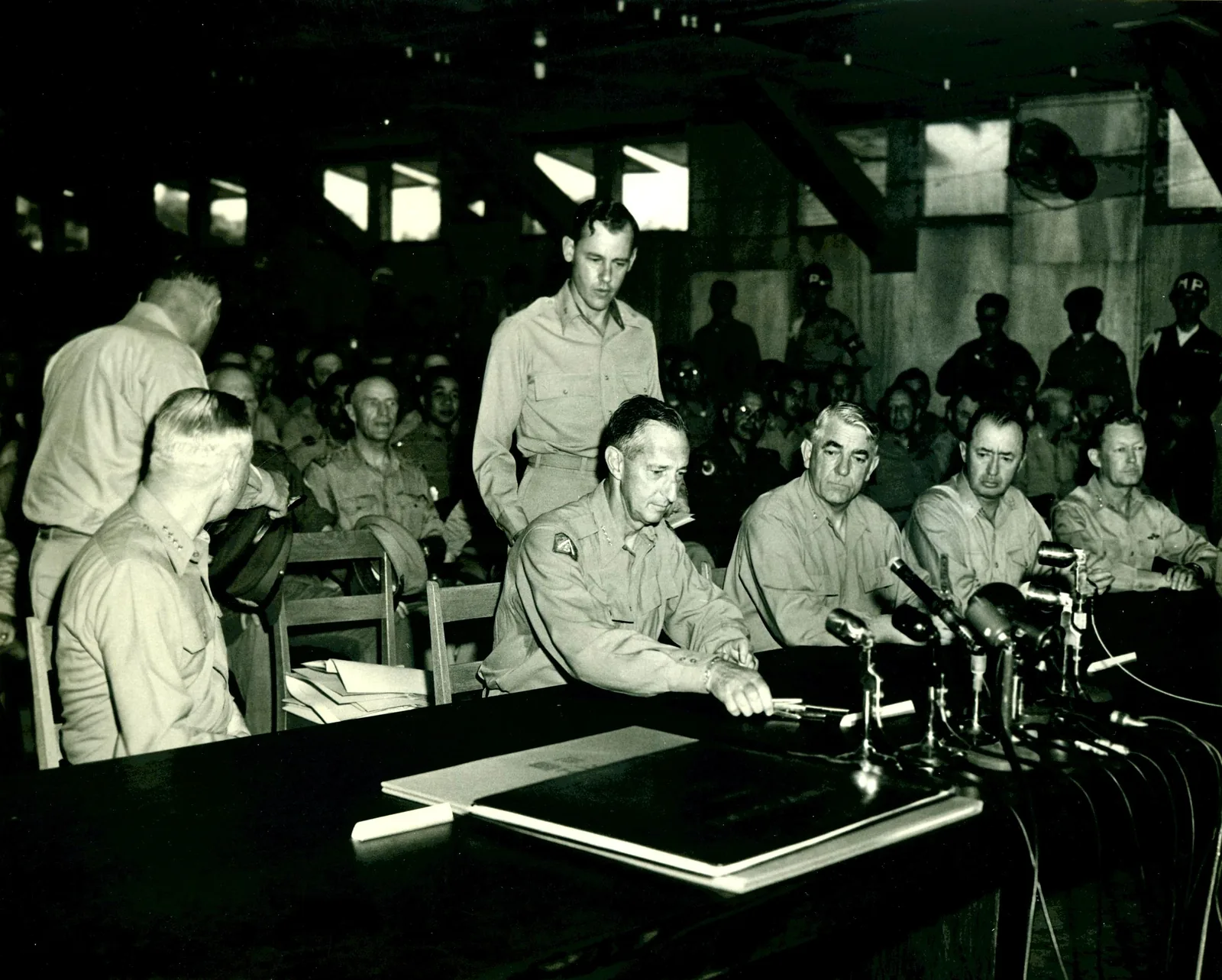 The signing of the Korean War armistice at Panmunjom, 27 July 1953.