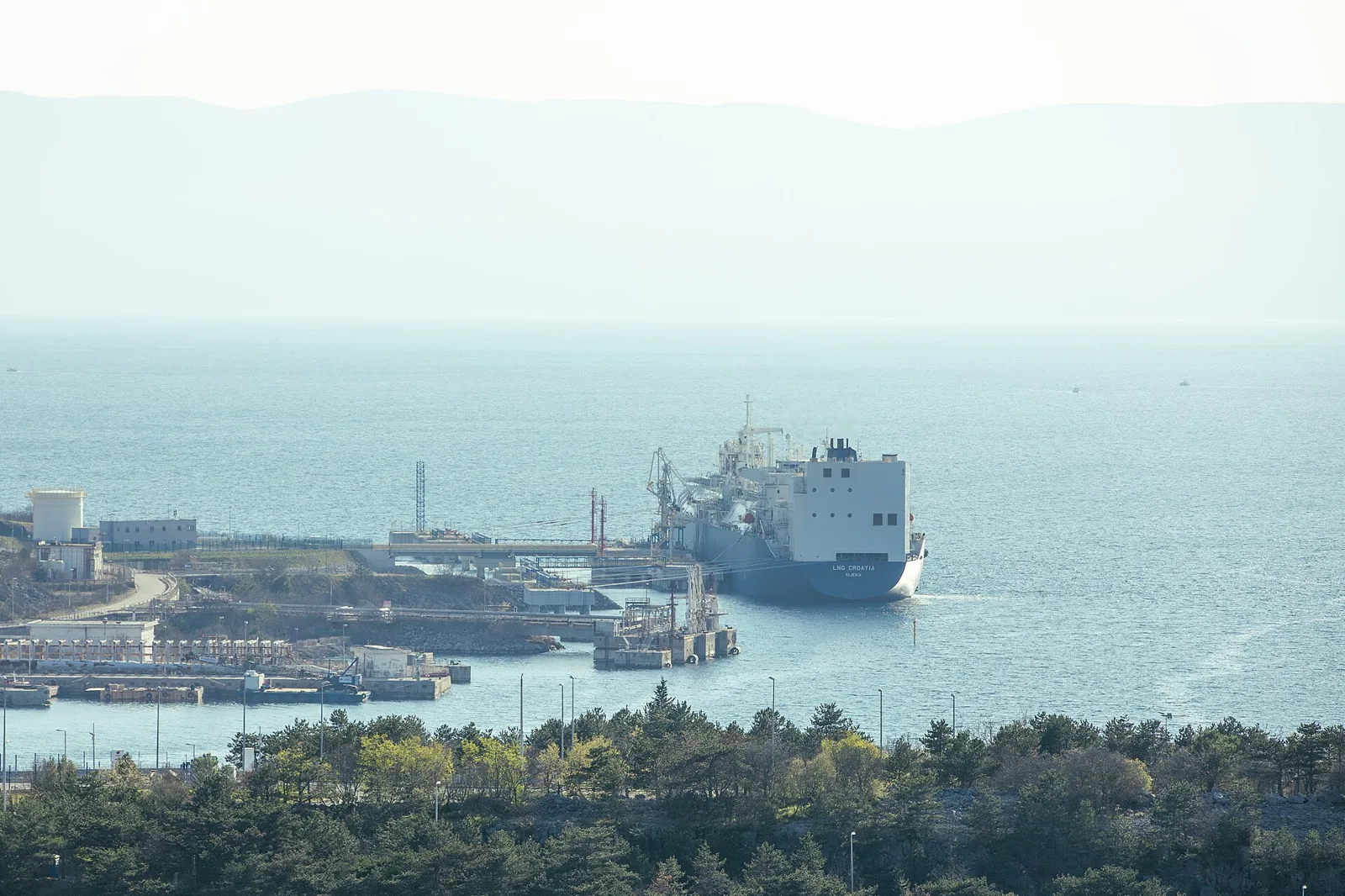 An LNG carrier berthed at a coastal terminal (file photo). LSEG analysts have warned that tanker targeting is reaching into the Gulf of Oman, jeopardising the ship-to-ship transfers that support Gulf crude loadings. This photo does not depict any vessel or event reported in this article.