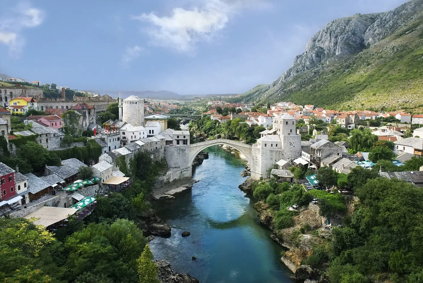 The Stari Most (Old Bridge) and old town of Mostar, in Herzegovina, seen across the Neretva River (file photo, 2007). Mostar was fought over by Croat and Bosniak forces in 1993-94; the bridge, destroyed in the war, was rebuilt after it. This photo does not depict the war.