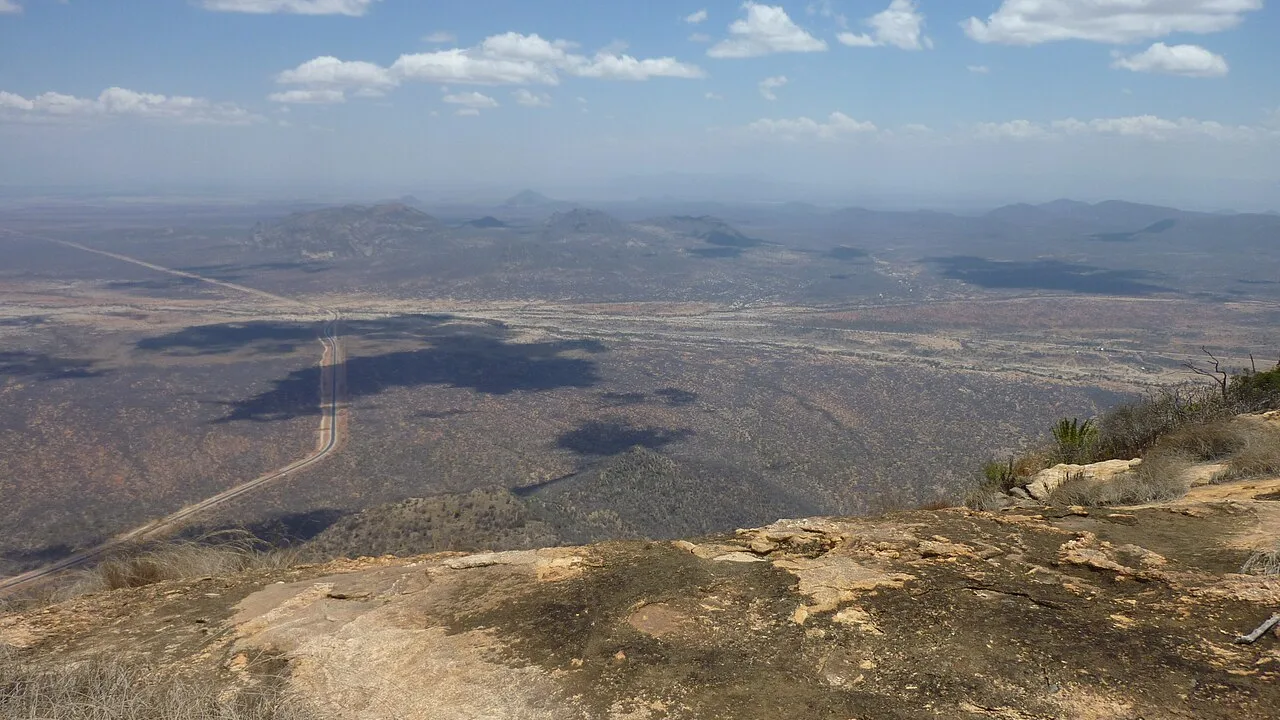 The Marsabit–Moyale road in northern Kenya, seen from a rocky hillside (file photo). Moyale, on the Ethiopia–Kenya border, is the main crossing on the road between Addis Ababa and Nairobi. This photo does not depict any event reported in this article.