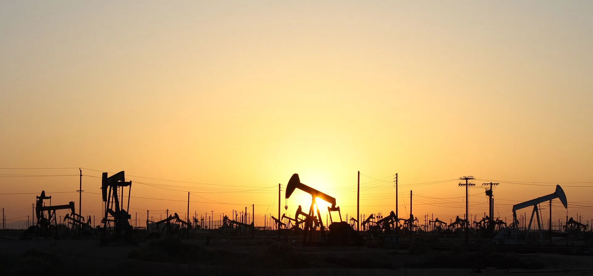 Oil pumpjacks silhouetted at sunset at an onshore oil field (file photo). Brent crude held near a five-month high on Tuesday as traders priced in a geopolitical risk premium. This photo does not depict any facility reported in this article.