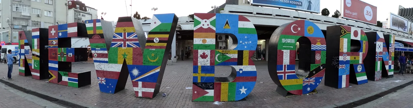 The NEWBORN monument in Pristina, unveiled on the day Kosovo declared independence, 17 February 2008, its letters painted with the flags of recognising states (file photo). The monument marks the outcome the 1999 settlement deferred; it does not depict the war.