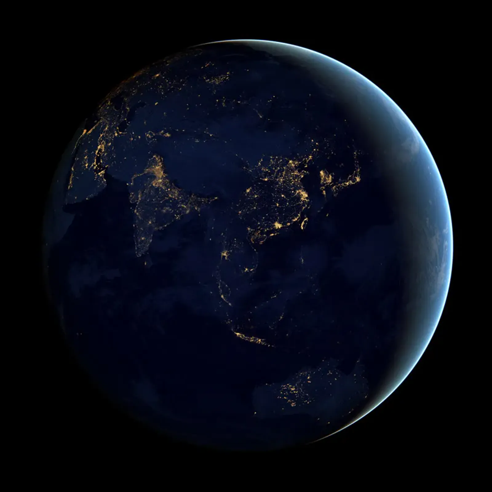 Earth at night, with city lights visible across Asia and the Pacific, in NASA's "Black Marble" imagery.