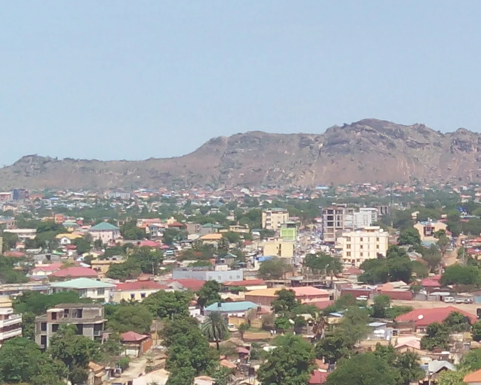 Residential neighborhoods of Juba, South Sudan, beneath a rocky mountain. Generic file photo — it does not depict the conflict described in this article.