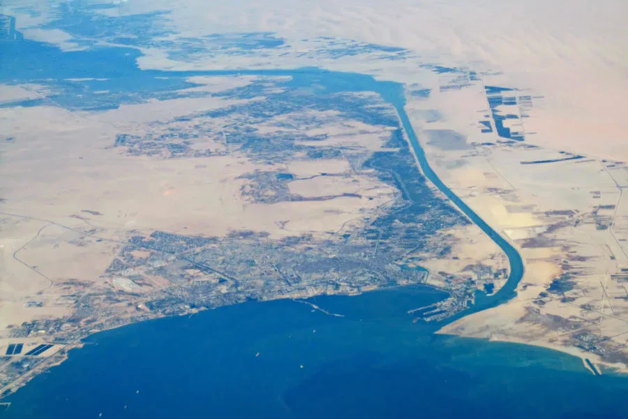 The city of Suez and the southern end of the Suez Canal seen from the air, the canal running north toward the Great Bitter Lake (file photo). Egypt nationalised the canal on 26 July 1956; it was blocked during the war and fully reopened on 24 April 1957. This photo does not depict the crisis.
