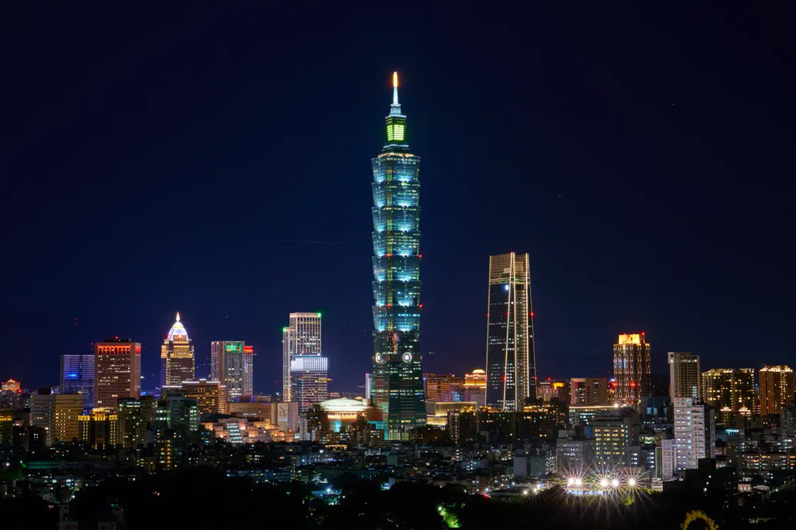The Taipei skyline at night, with Taipei 101 illuminated.