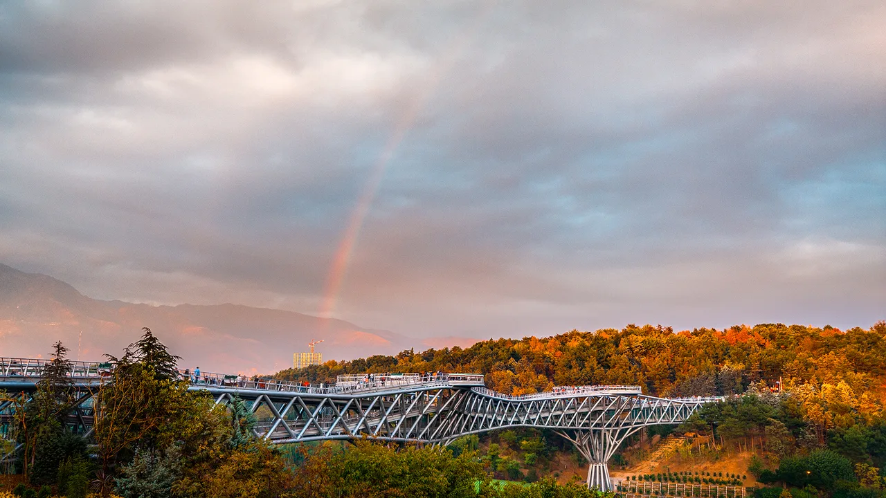 The Tabiat (Nature) Bridge in Tehran, Iran, under a rainbow at dusk (file photo). Tehran is expected to respond to the Qatari draft by the end of the week. This photo does not depict any event reported in this article.