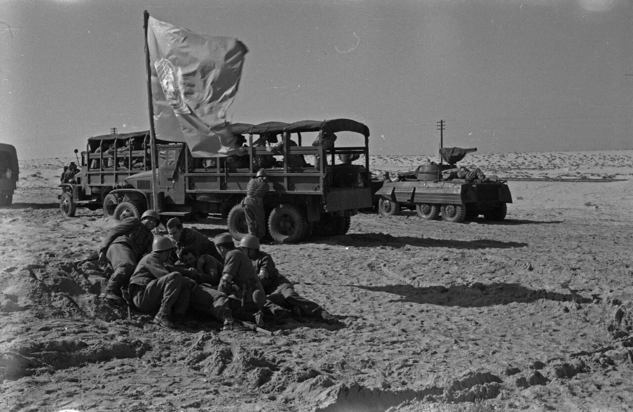 United Nations Emergency Force troops resting beside their trucks and the UN flag in the Sinai desert during the Suez Crisis (photograph by Zdravko Pečar, Museum of African Art, Belgrade). UNEF, the first armed UN peacekeeping force, supervised the invaders' withdrawal and then served as a buffer between Egyptian and Israeli forces until 1967.